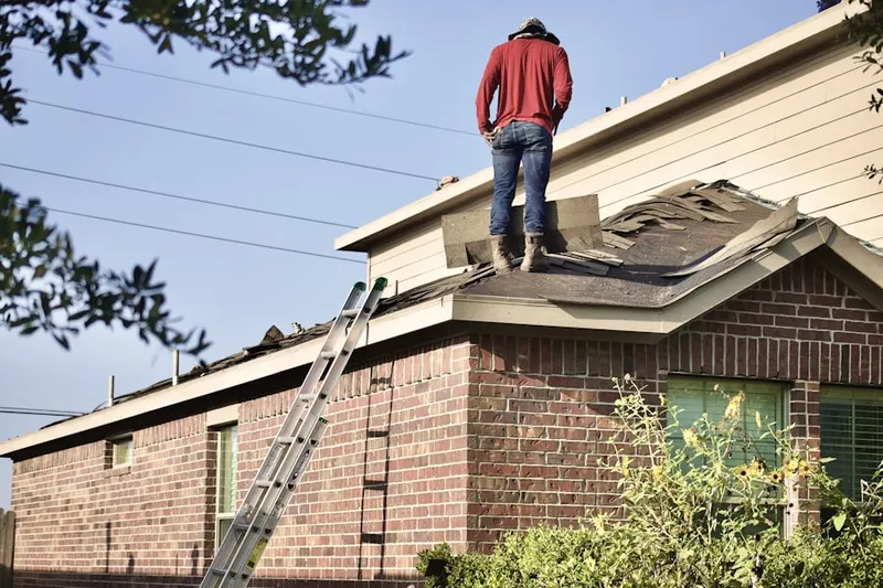 Professional roofer working on a residential roof in Little Creek